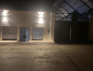 an empty building with two doors and lights on it at Condor Palace in Huayllay
