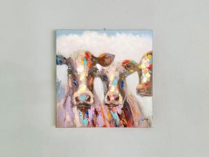 a painting of two cows standing next to each other at Sonnenhof Seeg 05 in Seeg