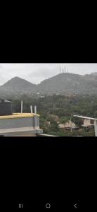 a view of a city with a mountain in the distance at Town Stays in Voi