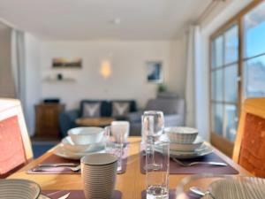 a dining room table with plates and glasses on it at Sonnenhof Seeg 07 in Seeg +16 photos