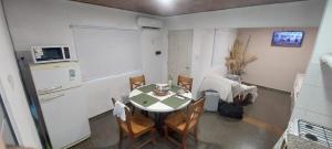 a kitchen with a table and chairs in a room at Bom Descanso in Realicó