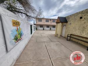 a wall with a mural on the side of a building at LOS CACTUS in Malargüe