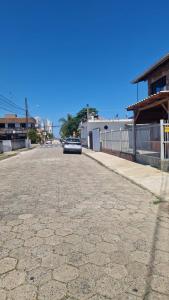 a car parked on the side of a street at Pousada Ju Haus in Navegantes
