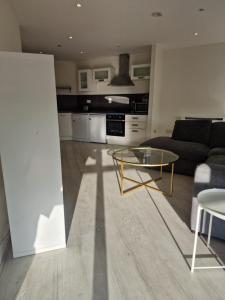 a living room with a couch and a glass table at Citywest 2 Bed Apartment in Citywest