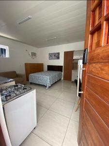 a kitchen with a stove and a bed in a room at ML Integra Mix kitnets in Maceió +11 photos