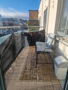 a balcony with two chairs and a view of the water at Citywest 2 Bed Apartment in Citywest