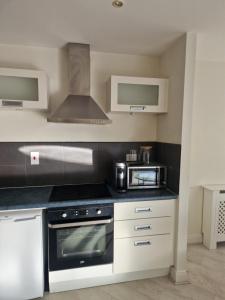 a kitchen with a stove and a microwave at Citywest 2 Bed Apartment in Citywest +12 photos