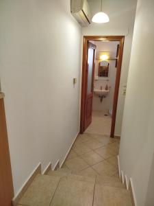 a hallway with a staircase leading to a bathroom at Margarita's home in Nísos Skýros