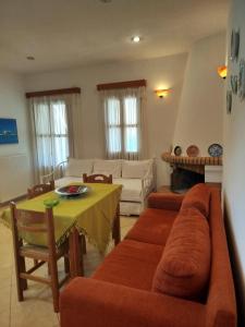 a living room with a couch and a table at Margarita's home in Nísos Skýros