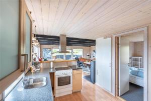 a kitchen with a sink and a stove top oven at 319-Hvide-Sande-Gammeleng-16 in Hvide Sande