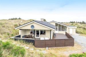 a house with a large deck on the beach at 319-Hvide-Sande-Gammeleng-16 in Hvide Sande