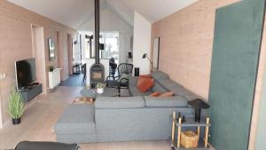 a living room with a couch and a tv at 753-Hvide-Sande-Slusen-53 in Hvide Sande