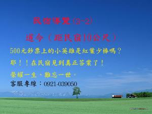 a sign with chinese writing and a tree in a field at 台東卑南公園民宿 in Taitung City