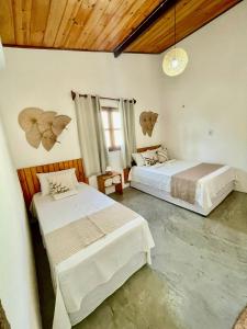 a bedroom with two beds in a room at Casa Ariacó in Amontada +3 photos