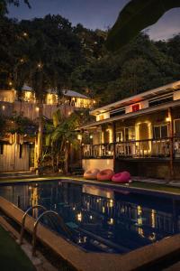 a hotel with a swimming pool at night at Hangover Chill & Hill Hostel in Phi Phi Islands