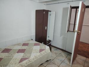 a bedroom with a bed and a closet and a door at Iquique Backpackers Beach House in Iquique +9 photos