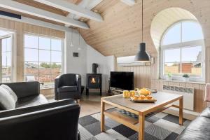 a living room with a couch and a table at 5537-Hvide-Sande-Vesterledvej-14 in Havrvig