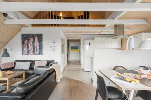 a living room with a couch and a table at 5537-Hvide-Sande-Vesterledvej-14 in Havrvig