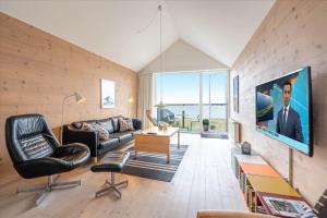 a living room with a couch and a tv at 717-Hvide-Sande-Slusen-17 in Hvide Sande