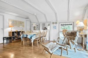 a dining room with a table and chairs at 602-Hvide-Sande-Nygardsvej-32 in Bjerregård