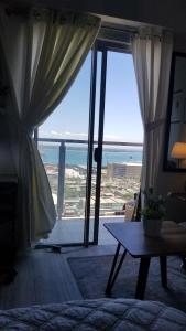 a living room with a view of the ocean at Sunvida tower Unit 1911 in front Sm Cebu in Cebu City
