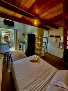 a bedroom with a bed with two towels on it at Ganesh Chalés in Boracéia +44 photos