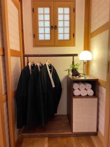 a closet with black shirts hanging on a rack at 응정헌 in Seoul +6 photos