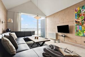a living room with a couch and a tv at 719-Hvide-Sande-Slusen-19 in Hvide Sande