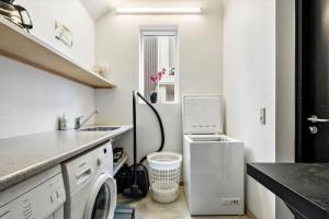 a small kitchen with a washing machine and a sink at 719-Hvide-Sande-Slusen-19 in Hvide Sande +36 photos
