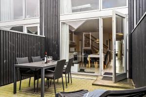 a dining room with a table and chairs on a balcony at 719-Hvide-Sande-Slusen-19 in Hvide Sande