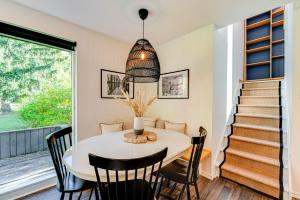 a dining room with a table and chairs and a staircase at D-Chalet - 9 personnes - 2 chambres in Beaupré