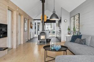 a living room with a couch and a fireplace at 707-Hvide-Sande-Slusen-7 in Hvide Sande