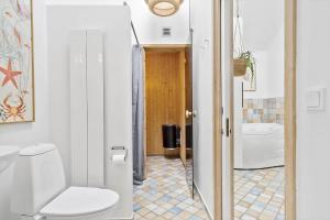 a bathroom with a toilet and a sink at 707-Hvide-Sande-Slusen-7 in Hvide Sande +27 photos