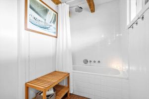 a white bathroom with a tub and a shower at 5507-Hvide-Sande-Tornbjerrevej-56 in Havrvig +24 photos