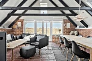 a living room with a table and chairs at 311-Hvide-Sande-Fyrmarken-7 in Hvide Sande
