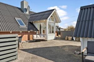 a house with a conservatory on a patio at 311-Hvide-Sande-Fyrmarken-7 in Hvide Sande