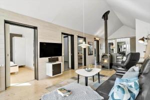 a living room with a couch and a tv at 703-Hvide-Sande-Slusen-3 in Hvide Sande
