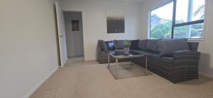 a living room with a couch and a table at Paradise on Snells Beach in Snells Beach