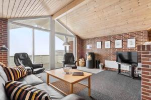 a living room with a brick wall at 513-Hvide-Sande-Riskrogvej-16 in Havrvig