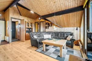 a living room with a couch and a table at 601-Hvide-Sande-Bjerregardsvej-375 in Bjerregård