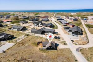 an aerial view of a village with houses and the ocean at 601-Hvide-Sande-Bjerregardsvej-375 in Bjerregård