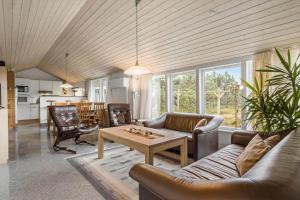 a living room with a couch and a table at 6623-Hvide-Sande-Bilbergsvej-18 in Bjerregård