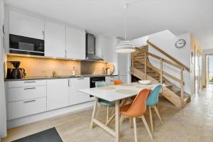 a kitchen with a table and chairs in a room at 731-Hvide-Sande-Slusen-31 in Hvide Sande