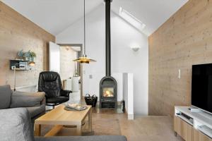 a living room with a couch and a fireplace at 731-Hvide-Sande-Slusen-31 in Hvide Sande
