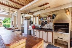 a large kitchen with a large oven in it at Chácara Recanto do Sossego in Morretes
