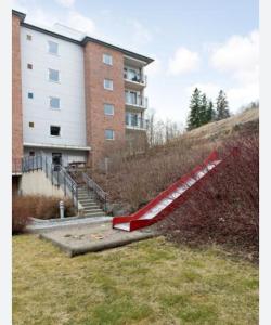 a red slide in front of a building at Klaus torgårds vei 8b in Oslo