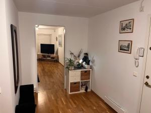 a living room with white walls and a television at Klaus torgårds vei 8b in Oslo