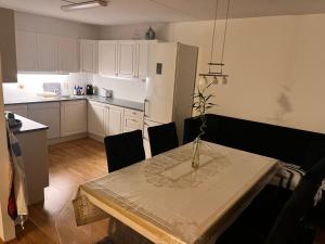 a kitchen with a table with a vase on it at Klaus torgårds vei 8b in Oslo