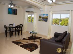 a living room with a couch and a table at Luxury GuestHouse Suites in Cap-Haïtien
