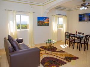 a living room with a couch and a table at Luxury GuestHouse Suites in Cap-Haïtien